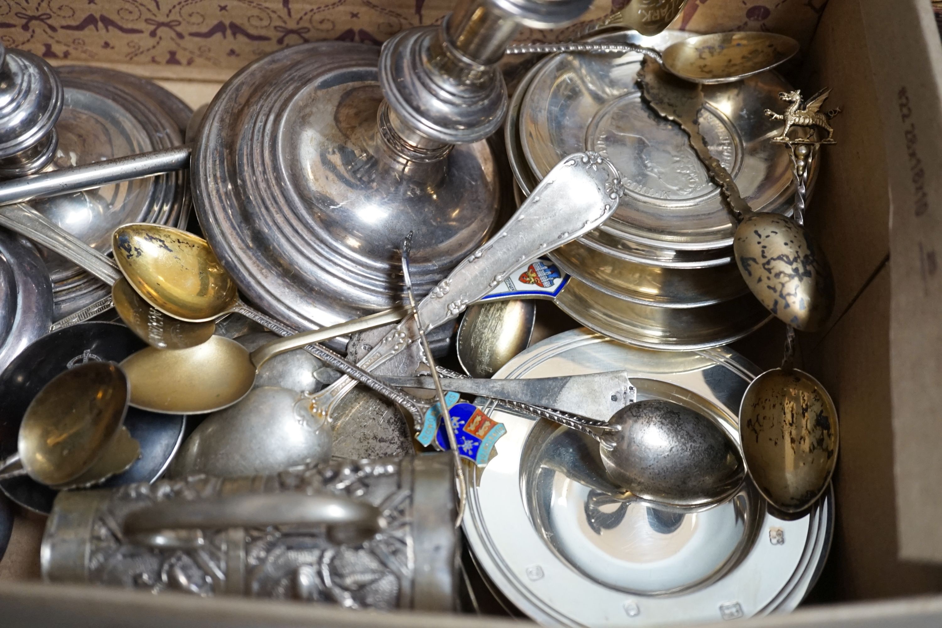 A pair of 1960's silver candlesticks, 19.2cm, weighted, a small silver vase, small silver and tortoiseshell pill box, two small silver armada dishes, two Indian white metal cream jugs, four 'coin' dishes, a quantity of a